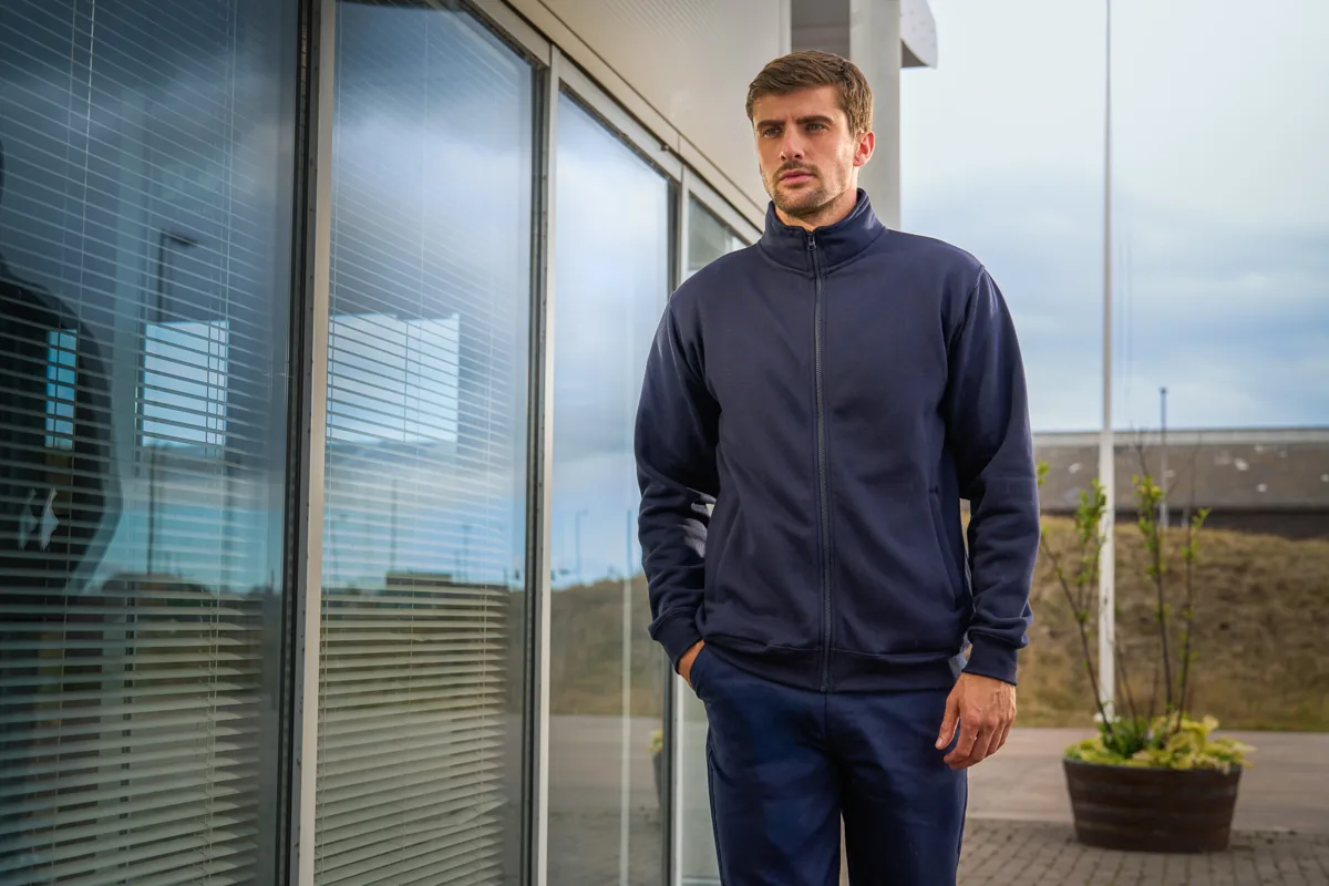 Navy PRO RTX softshell jacket worn outside an office